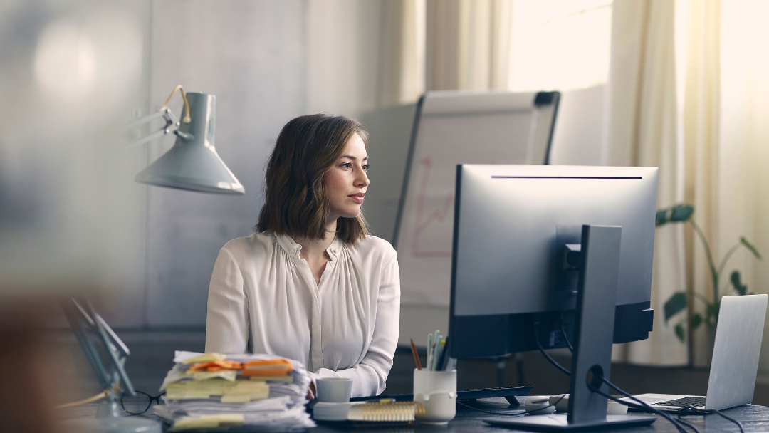 Woman at desk looking at computer