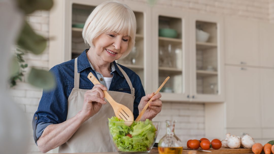 Elderly women cooking healthy meal