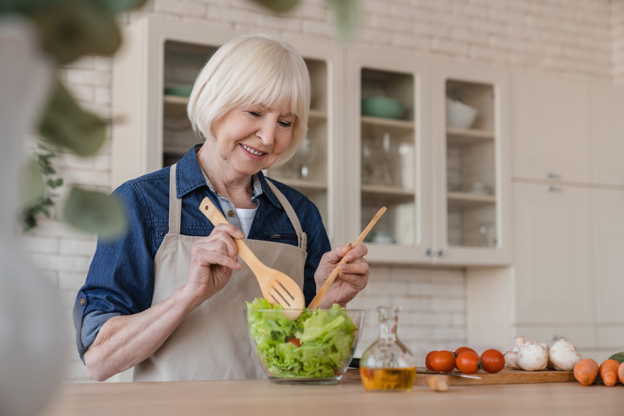 Elderly women cooking healthy meal